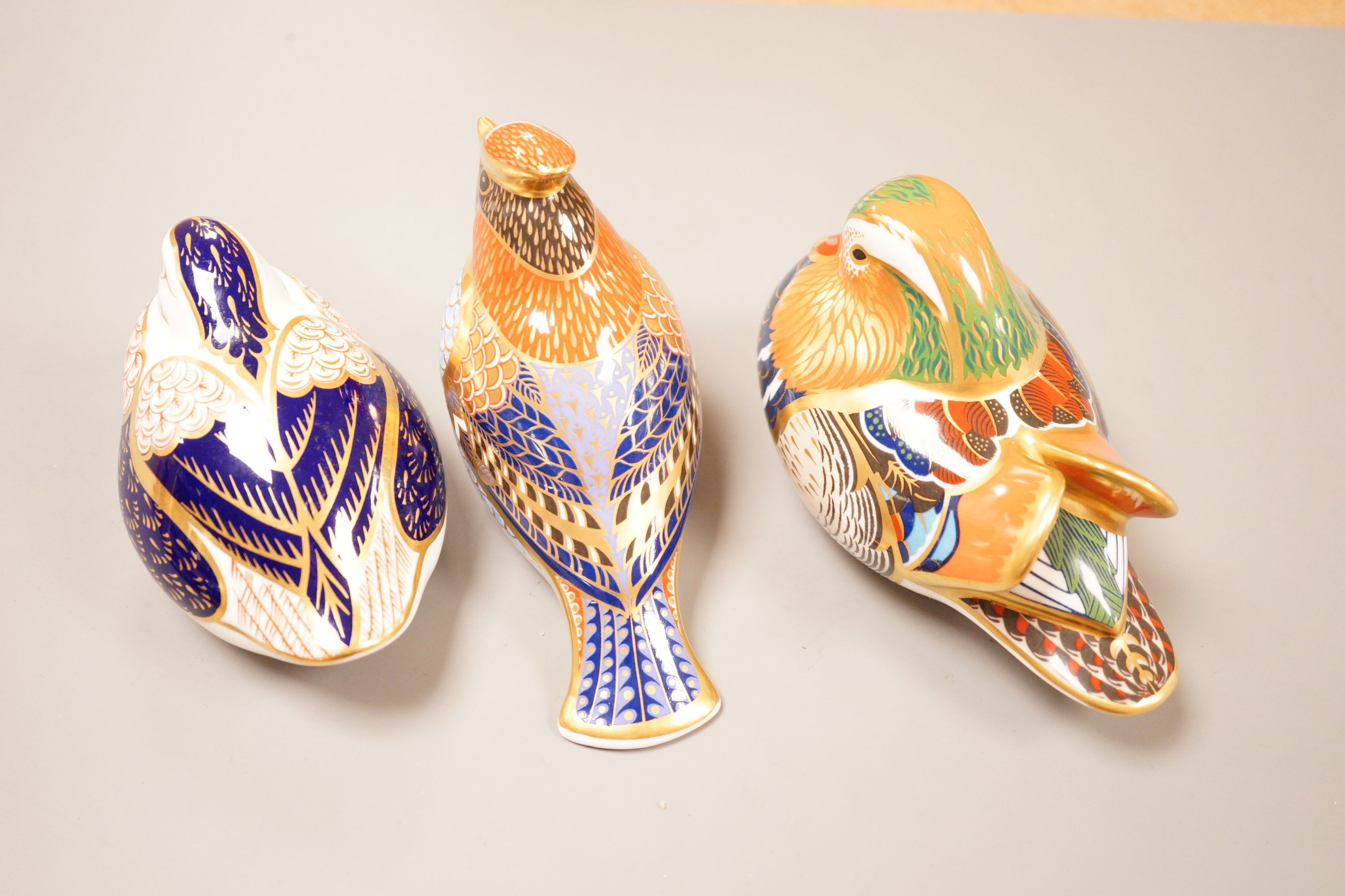 Three Royal Crown Derby Imari paperweights; a duck and two birds, silver badge